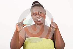 Woman in towel holding a natural soap