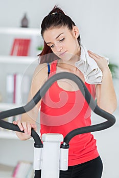 Woman towelling herself off while exercising photo