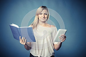 Woman with traditional book and e-book reader tablet