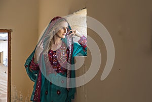 a woman in traditional Omani dress in a countryside of UAE