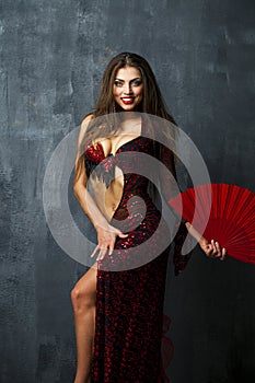 Woman traditional Spanish Flamenco dancer dancing in a red dress