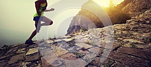 Woman trail runner on the great wall top of mountain
