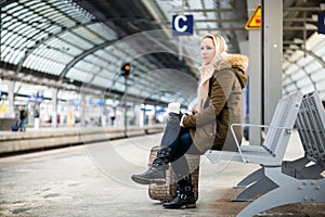 Woman on train station platform waiting