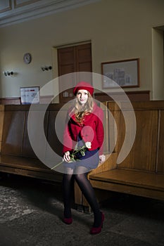 Woman at train station with rose