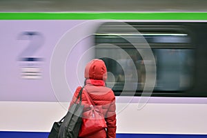 Woman at train station speeding train