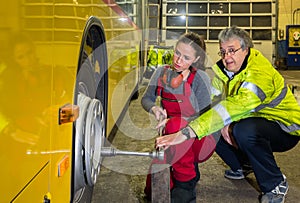 Woman, trainee, working in the bus Workshop