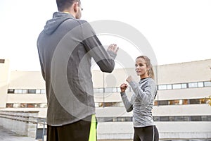 Woman with trainer working out self defense strike