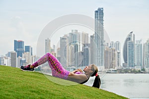 Woman Training ABS And Working Out In City Park photo