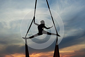 Woman training acrobatic in air.