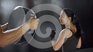 Woman training boxing personal trainer. Instructor teaching female boxer fighting practice together.