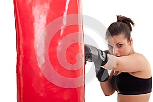 Woman training in boxing on punching bag