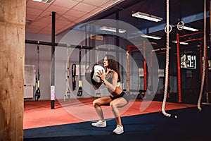 Woman training with functional gymnastic in the gym