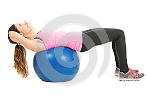Woman training her abs on pilates ball