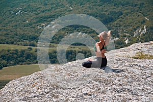 Woman training on high mountain. Contemplation, sport or Yoga time concept. Enjoying virgin nature view. Green hills.