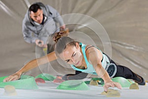 Woman training at indoor climbing gym wall