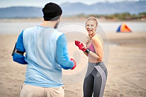 Woman training kickbox with a coach; Active lifestyle concept