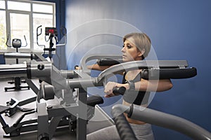 Woman is training the muscles of her shoulders