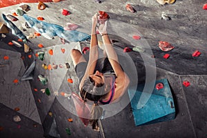 Woman training on practice climbing wall indoor