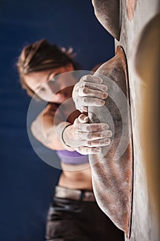 Woman training on practice climbing wall