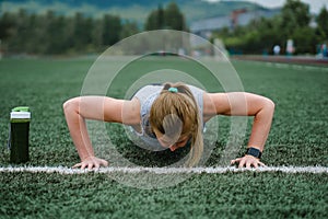 Woman training at the stadium. Physical activity and endurance. photo