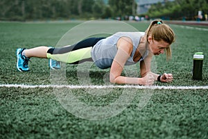 Woman training at the stadium. Physical activity and endurance. photo