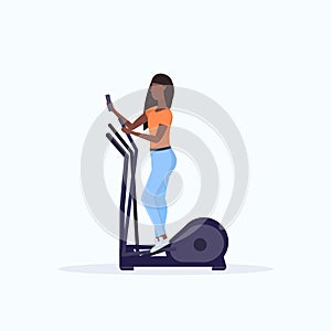 Woman training on stepper treadmill african american girl using smartphone while working out gym digital gadget