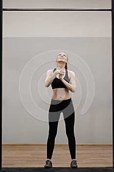 Woman trains on horizontal bars in the gym