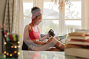 Woman Transferring Photos From Camera To Laptop Wirelessly