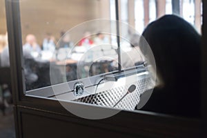 woman in translators cubicle