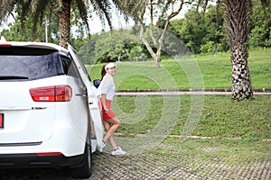 Woman travel by car to golf, woman loading a golf bag