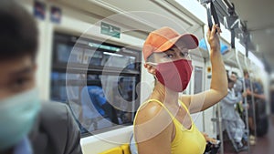 Woman travel caucasian ride at overground train airtrain with wearing protective medical mask. Girl tourist at airtrain photo