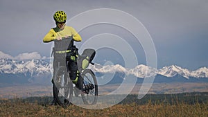 The woman travel on mixed terrain cycle touring with bikepacking. The traveler journey with bicycle bags. Sport tourism