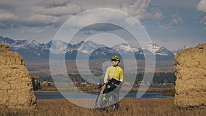 The woman travel on mixed terrain cycle touring with bikepacking. The traveler journey with bicycle bags. Sport tourism