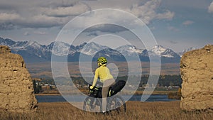 The woman travel on mixed terrain cycle touring with bikepacking. The traveler journey with bicycle bags. Sport tourism