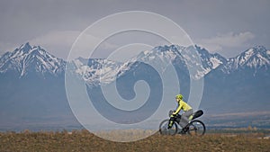 The woman travel on mixed terrain cycle touring with bikepacking. The traveler journey with bicycle bags. Sport tourism