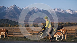 The woman travel on mixed terrain cycle touring with bikepacking. The traveler journey with bicycle bags. Sport tourism