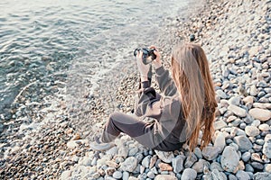 Woman travel sea. Happy tourist enjoy taking picture outdoors for memories. Woman traveler looks at sea bay of mountains