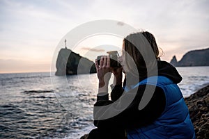 Woman travel sea. Happy tourist enjoy taking picture outdoors for memories. Woman traveler looks at sea bay of mountains