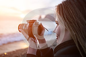 Woman travel sea. Happy tourist enjoy taking picture outdoors for memories. Woman traveler looks at sea bay of mountains