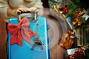 Woman with travel suitcase and Eiffel tower souvenir