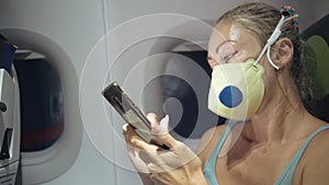 Woman travel tourist caucasian at plane aircraft with wearing protective medical mask. Read shock news about coronovirus