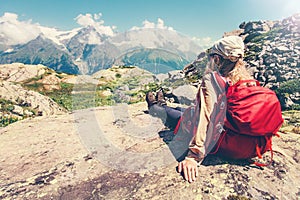 Woman Traveler with backpack admiring of mountains
