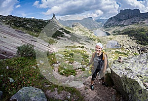 Woman Traveler with Backpack hiking in Mountains with beautiful Himalaya landscape on background mountaineering sport