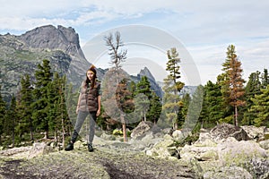 Woman Traveler with Backpack hiking in Mountains with beautiful Himalaya landscape on background mountaineering sport