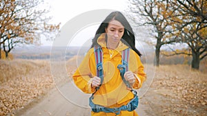 Woman traveler with backpack hiking in mountains. Hiker walking in the mountains, freedom and happiness, achievement in