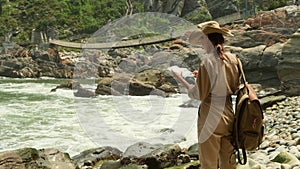 woman traveler with a backpack made a halt on the ocean near the hanging place