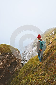 Woman traveler with backpack standing alone outdoor