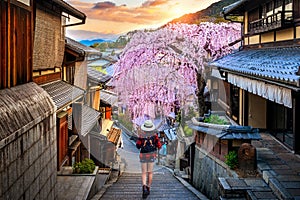 Woman traveler with backpack walking at Historic Higashiyama district in spring, Kyoto in Japan.