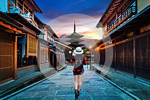 Woman traveler with backpack walking at Yasaka Pagoda and Sannen Zaka Street in Kyoto, Japan.