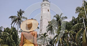 Woman Traveler in Dress and Hat in Front of Famous Landmark of Sri Lanka Country, Dondra Lighthouse